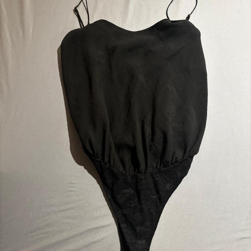 Free People Black lace bodysuit with spaghetti straps and a fitted silhouette